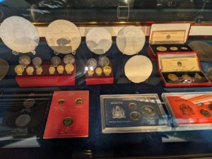 display case with coins and bills 